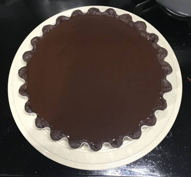 pour melted chocolate into tart