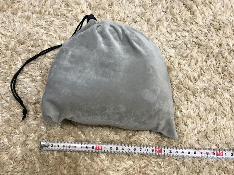 measuring GUAPO neck pillow in a bag
