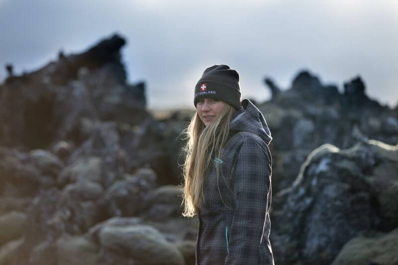 a woman wearing a coat and woolen hat