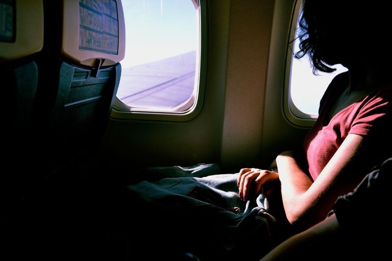 a woman sitting a seat of airplane