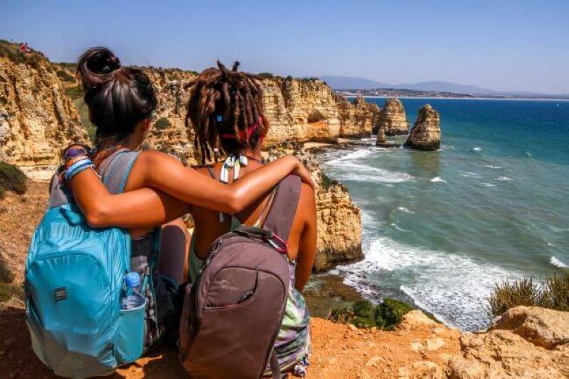 two girls looking at the sea